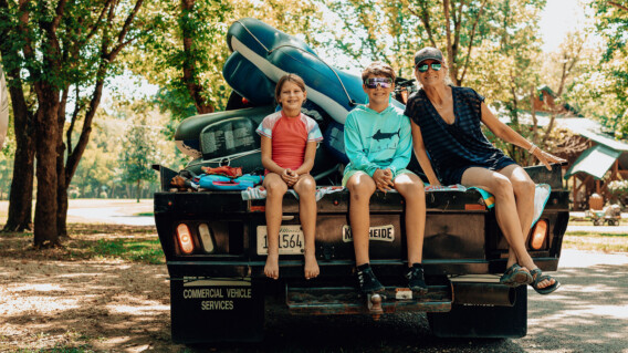 Ozark outdoors family siting on back of truck